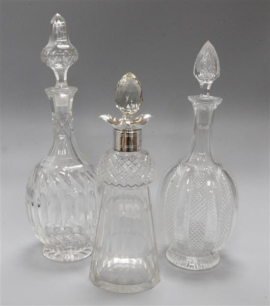 A silver mounted decanter and two other decanters